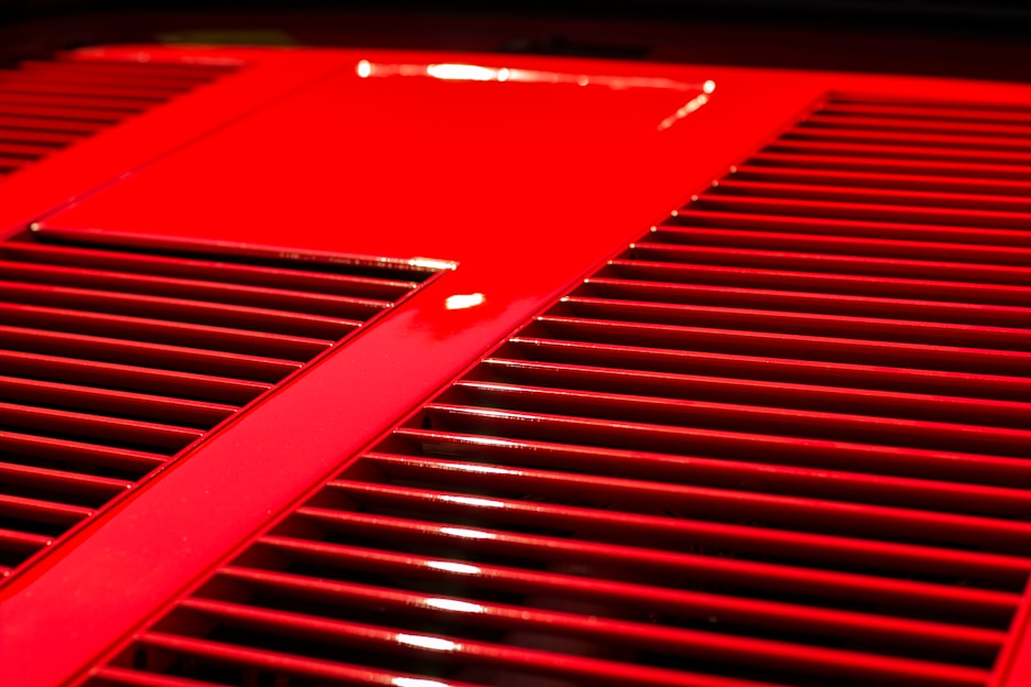 Close-up of a sleek air blower in vibrant red, highlighting its compact design and sturdy build.