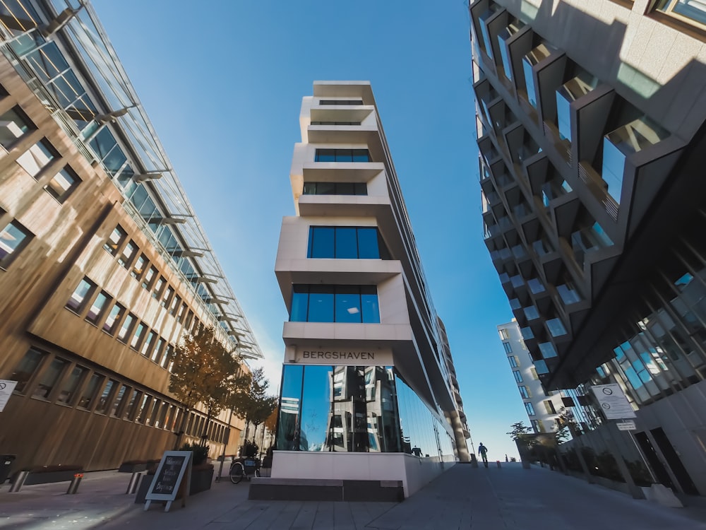 Fotografia dal basso di edifici in cemento bianco e rosa durante il giorno