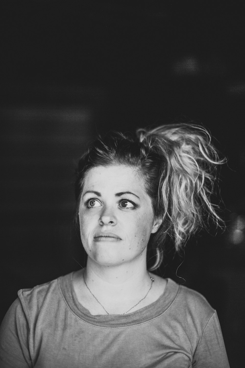 grayscale photo of woman wearing scoop-neck top