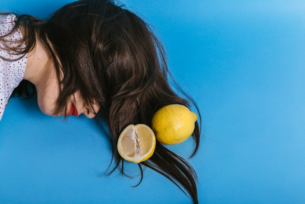 woman's head beside lemon