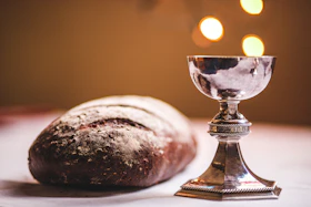 gray footed cup beside baguette bread