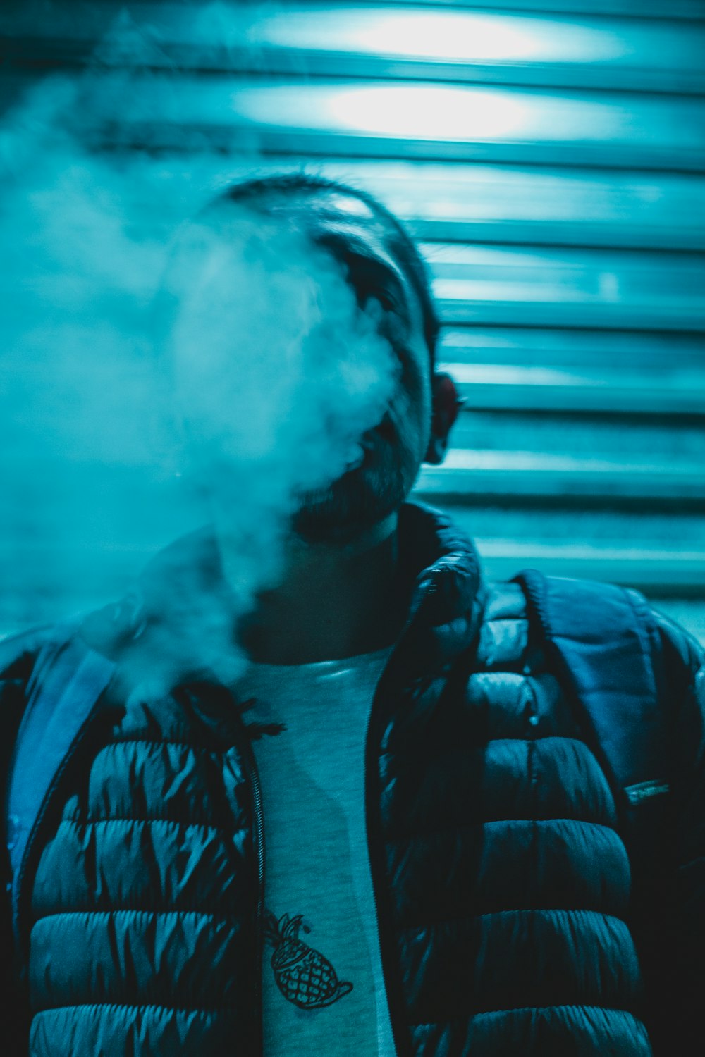 man blowing smoke