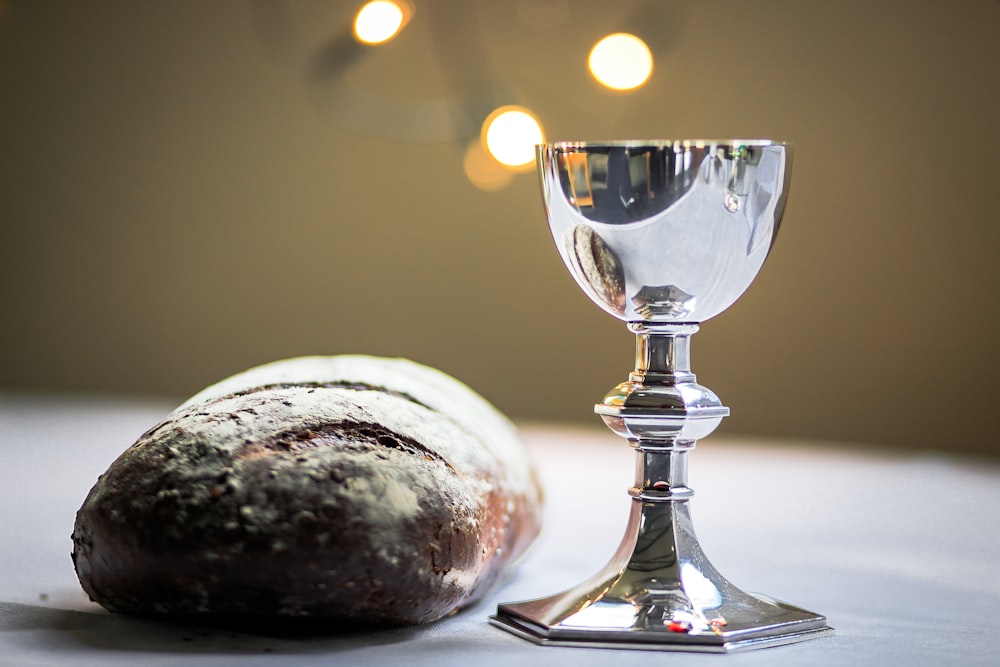 gray stainless steel chalice and bread bun