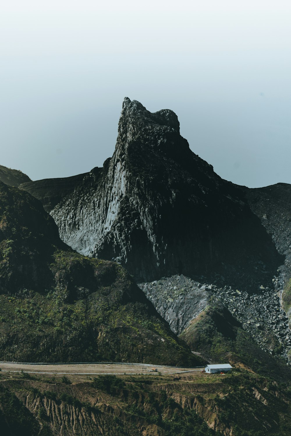 black and brown rock formation under white sky