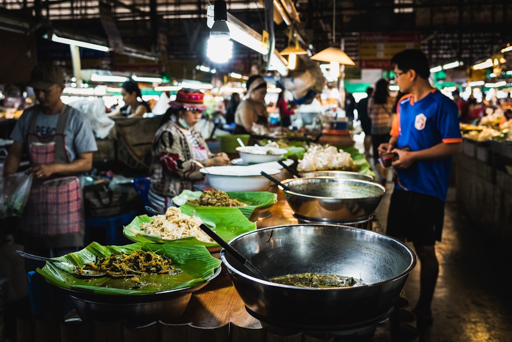 man in blue shirt standing in front of counter