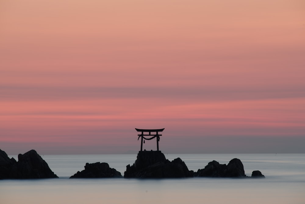 silhouette of arch on rock formation