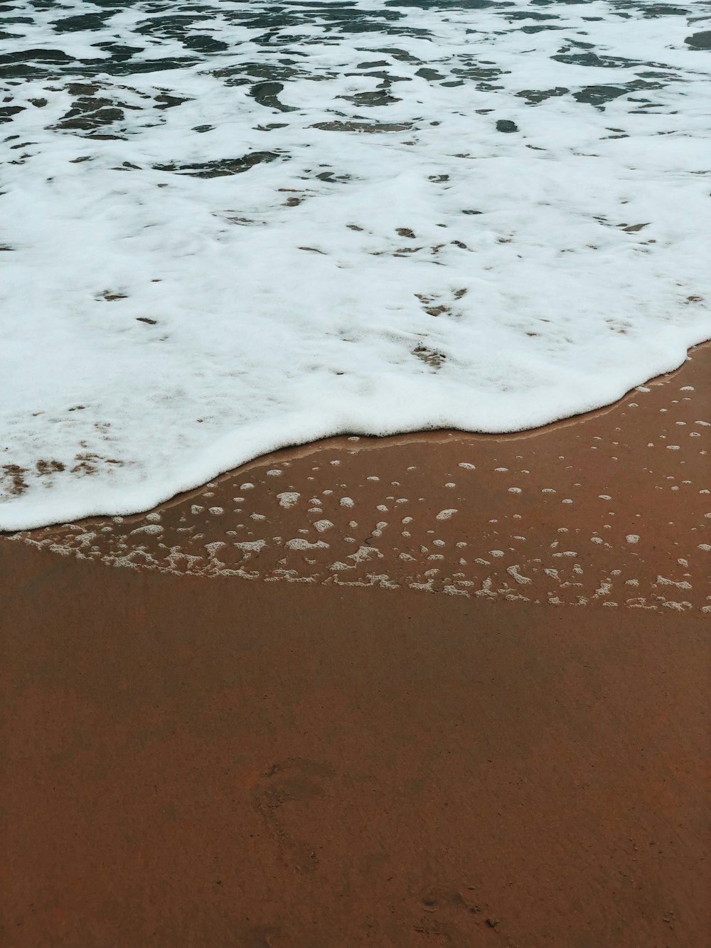 sea waves on brown seashore during daytime