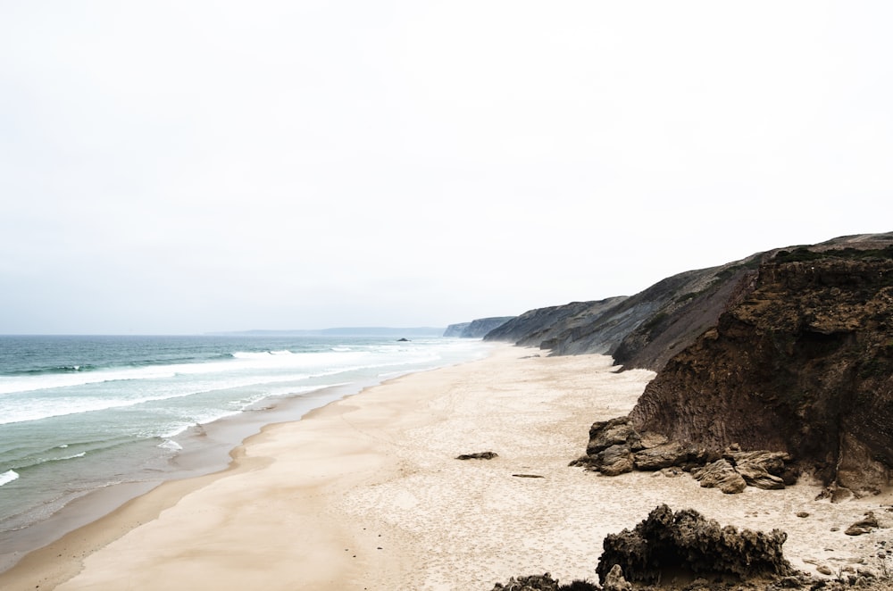 brown cliff near seashore