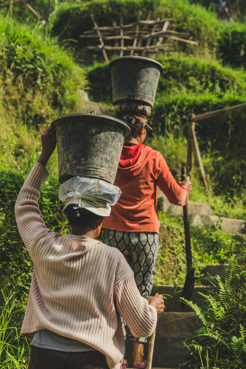 woman with buckets on heads