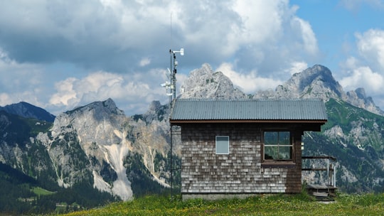 brown house across glaciers mountains in Tyrol Austria