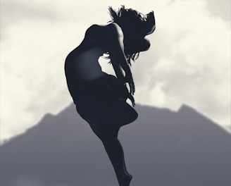 silhouette of person jumping in mid-air during daytime