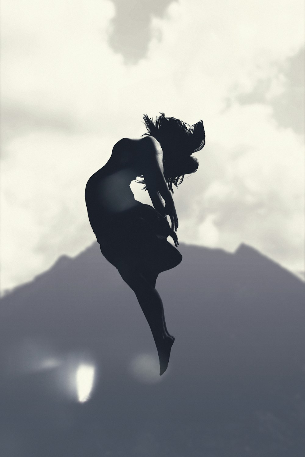 silhouette of person jumping in mid-air during daytime
