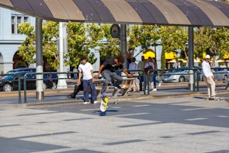 A group of friends skateboarding in an urban setting.