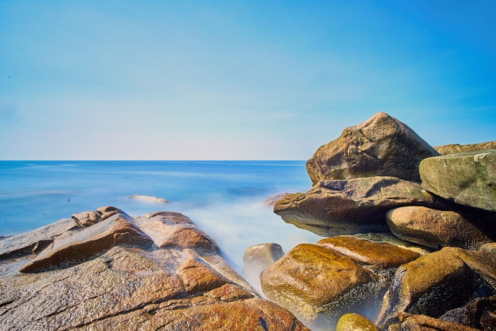 sea breeze on brown piled rocks