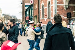 A peaceful street in Geneston with people walking and chatting, symbolizing community life.