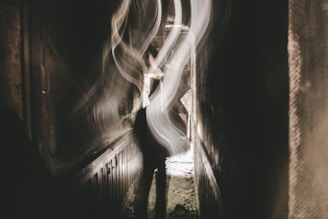 A dimly lit hallway with flickering lights and shadows lurking in corners.