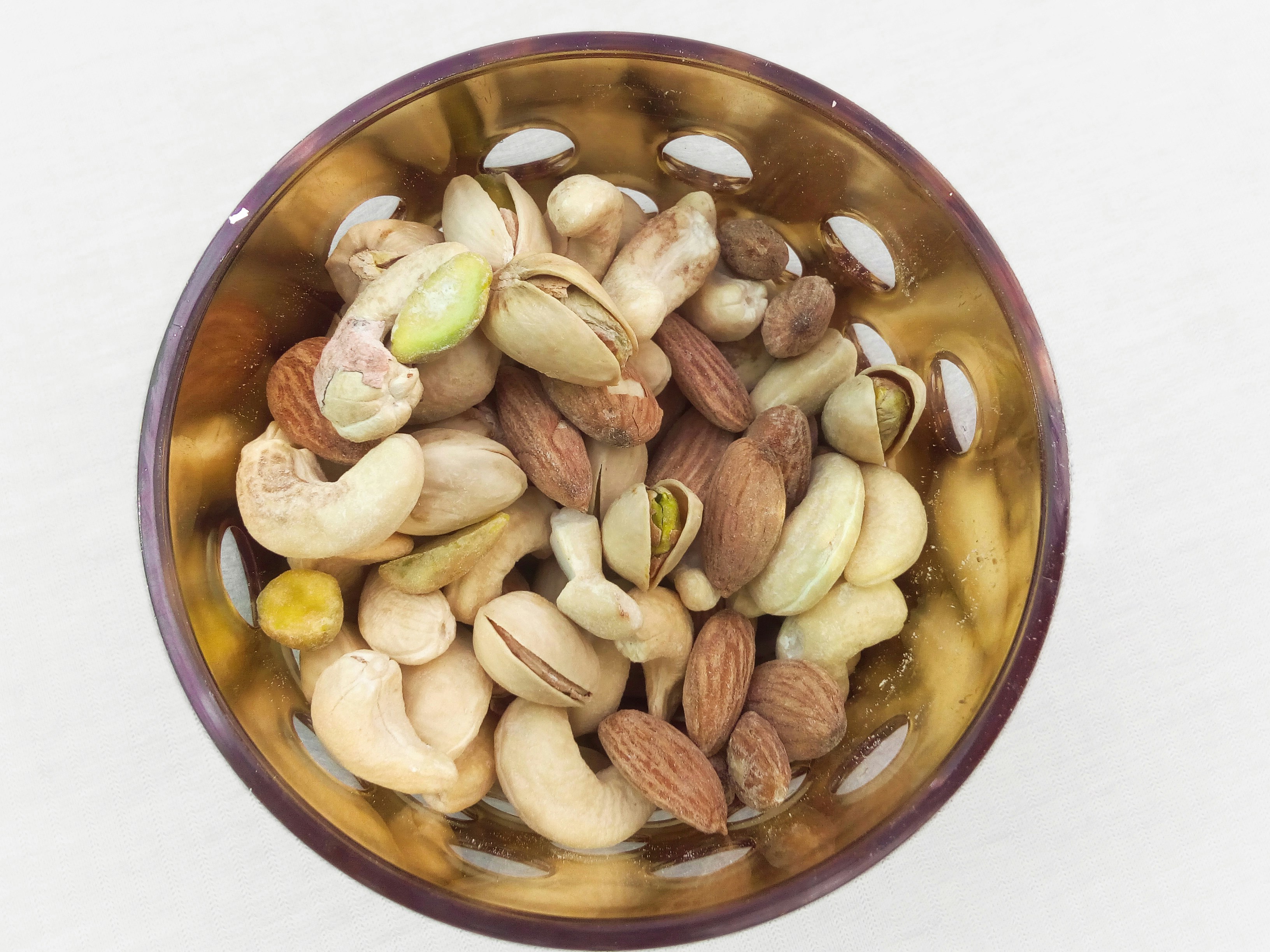 Assorted mixed nuts including almonds, cashews, and walnuts in bowl