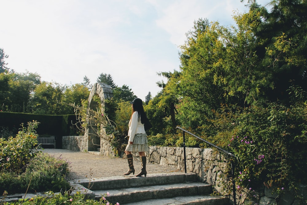 candid photography of woman standing at staircase outdoors