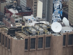 Photo of a commercial rooftop in Midtown Manhattan with workers installing new roofing materials