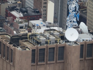 Photo of a commercial rooftop in Midtown Manhattan with workers installing new roofing materials