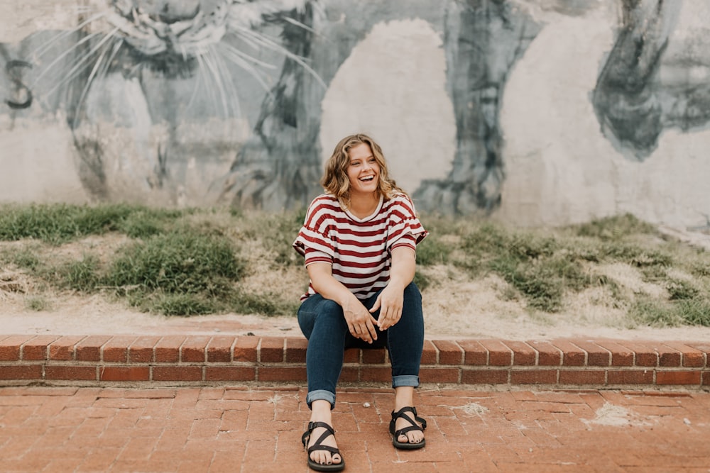 woman sitting on brick tile