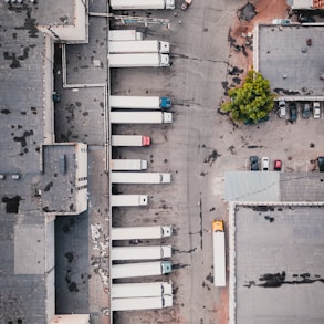 aerial view of trucks on gray commercial building during daytime