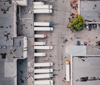 aerial view of trucks on gray commercial building during daytime