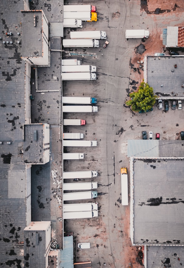 aerial view of trucks on gray commercial building during daytime