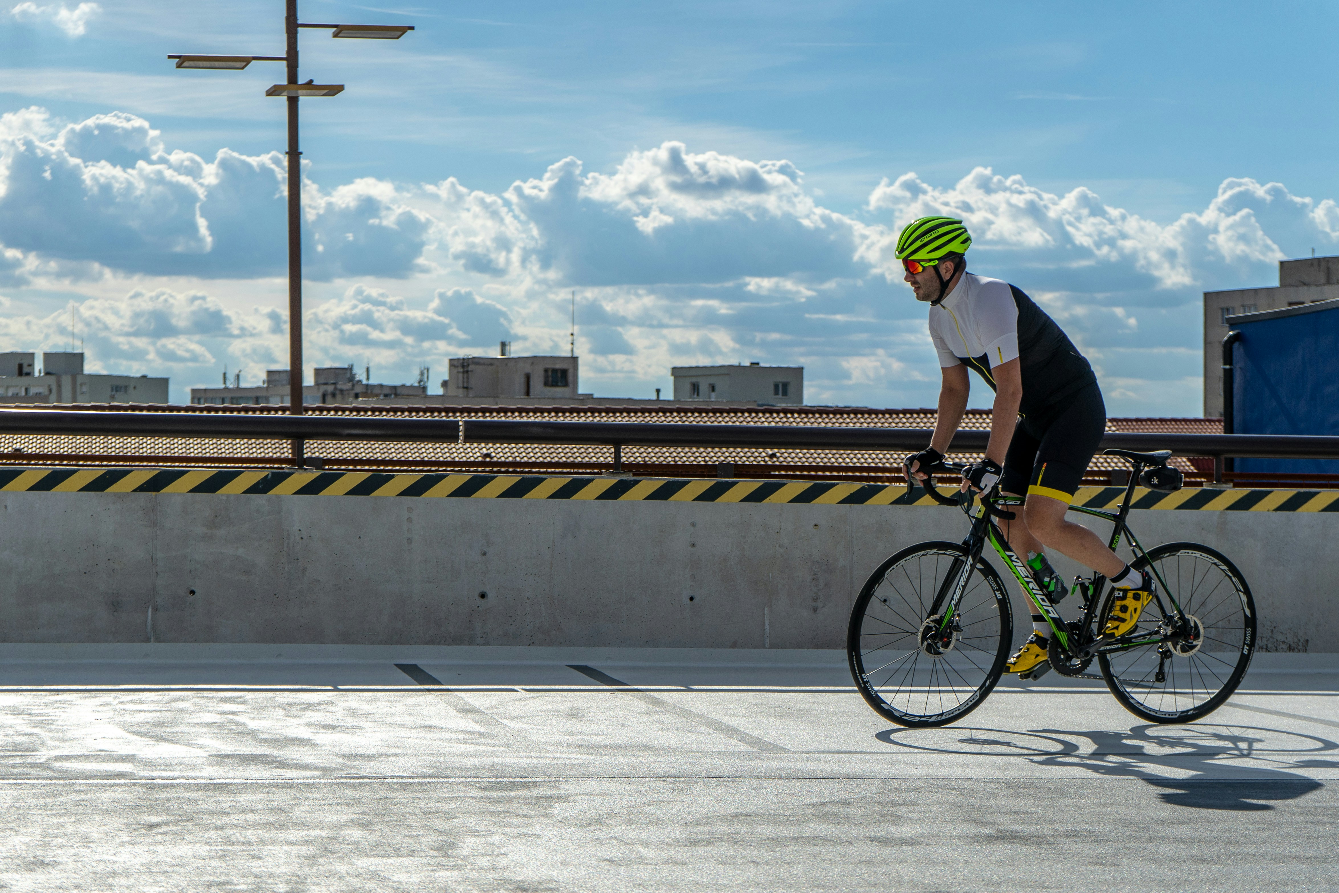 man riding on road bike