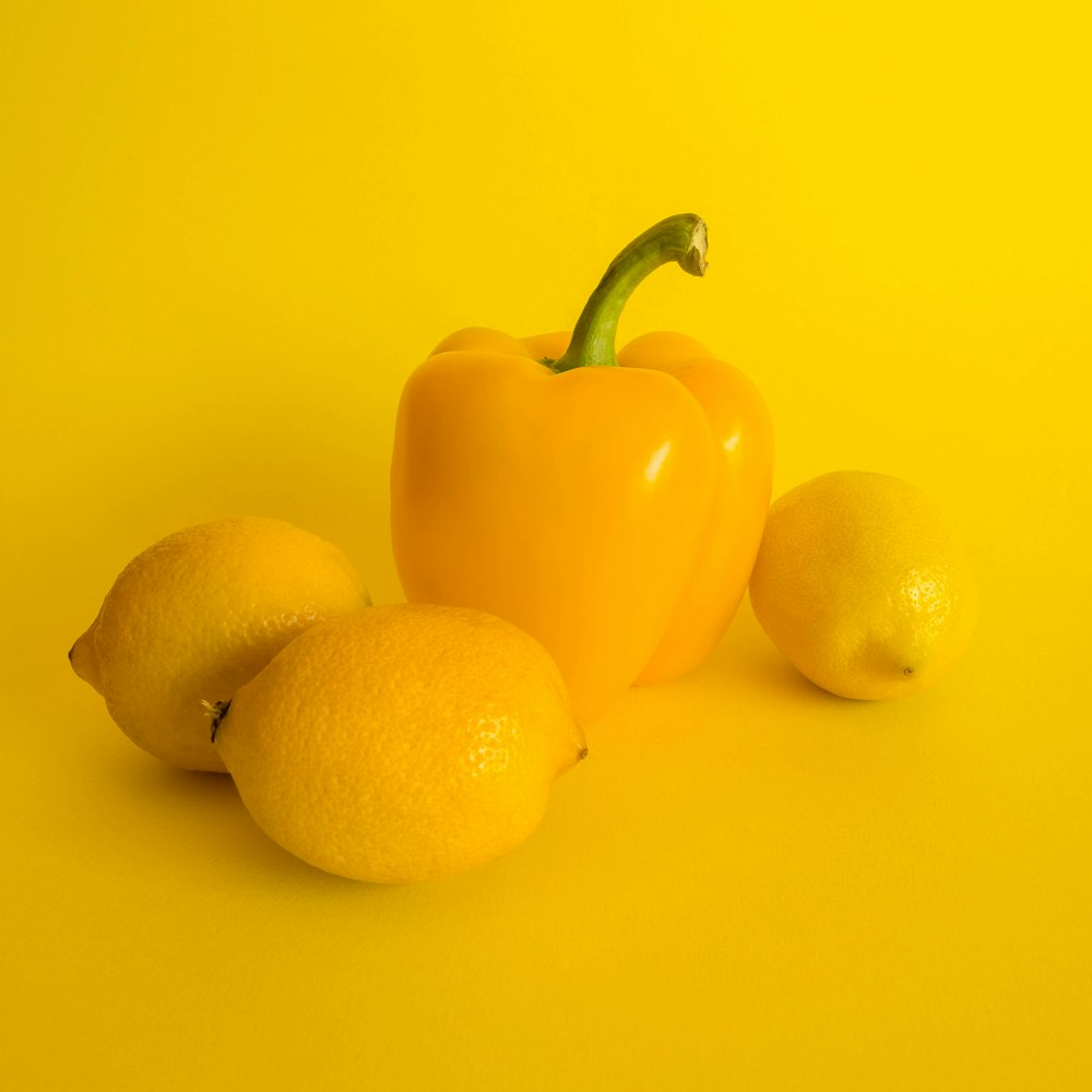 three lemons and yellow bell pepper