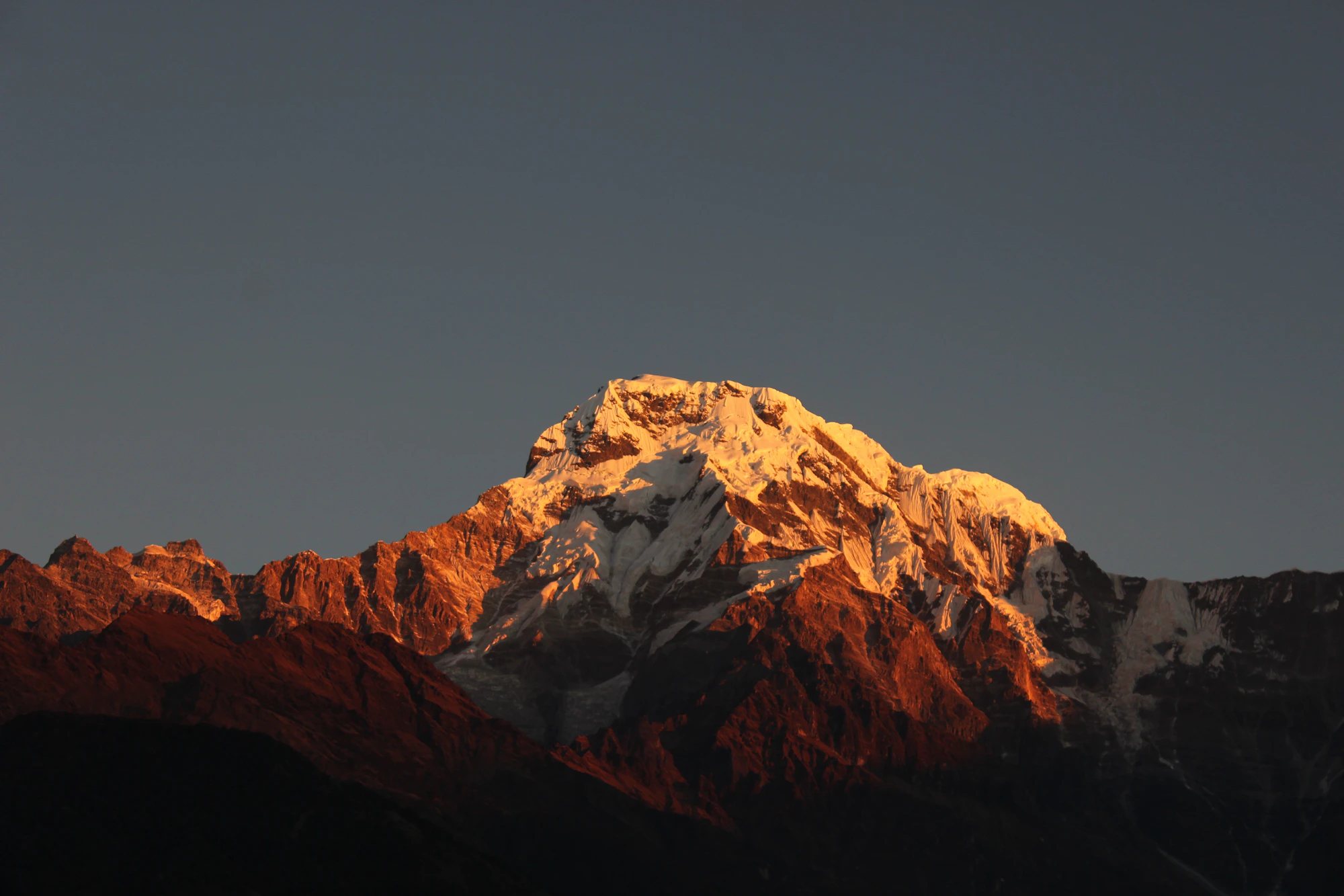 Stone Himalayan village beneath snow-dusted peaks in the Manaslu region, Nepal