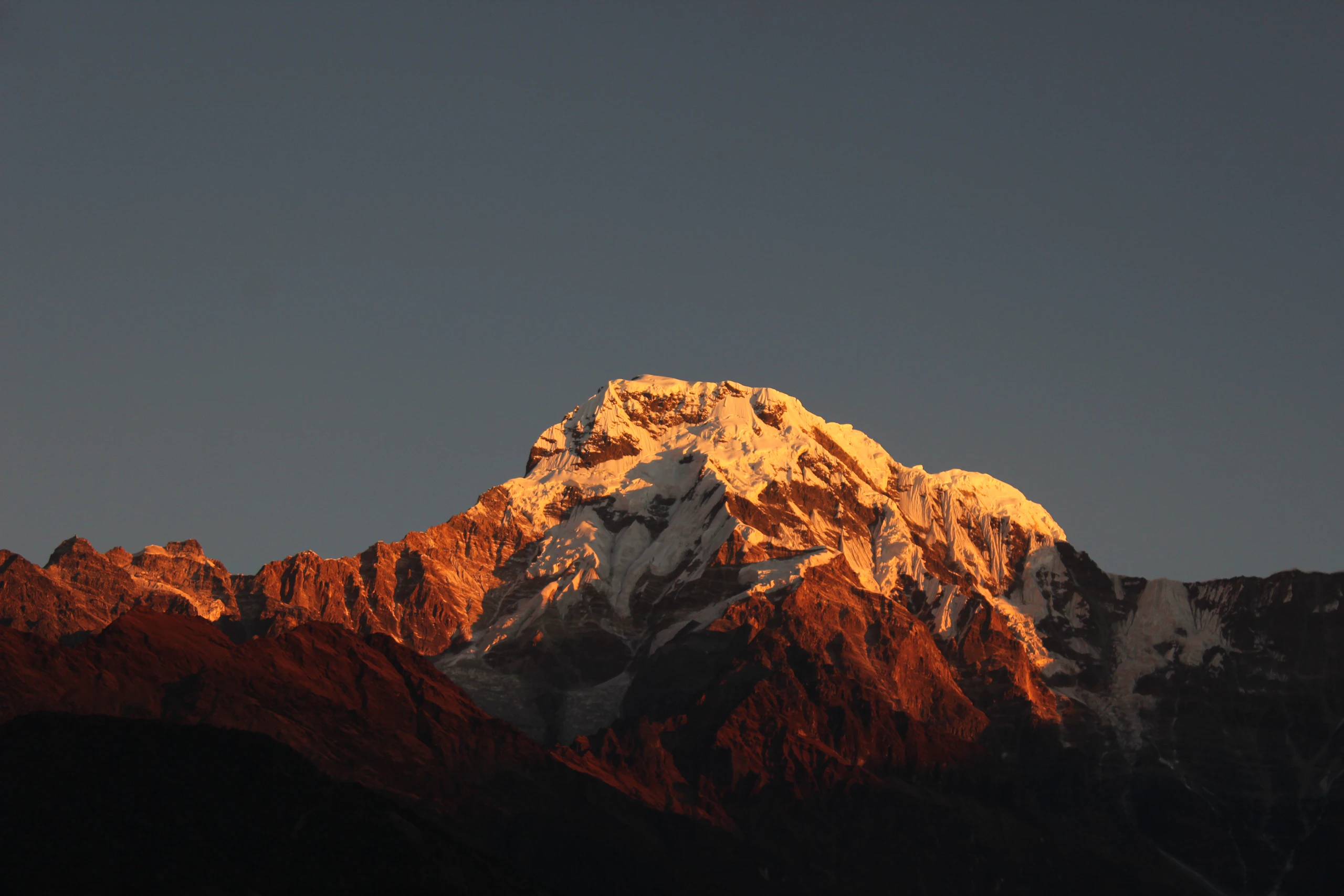 Stone Himalayan village beneath snow-dusted peaks in the Manaslu region, Nepal