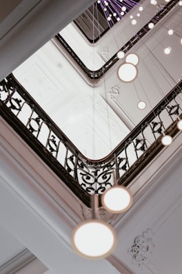 View of the beautiful staircase with intricate iron railings inside the boutique hotel.