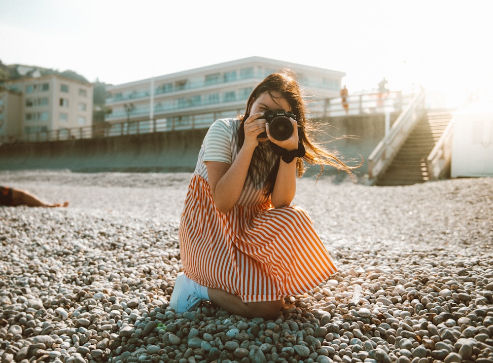 woman holding camera taking photo