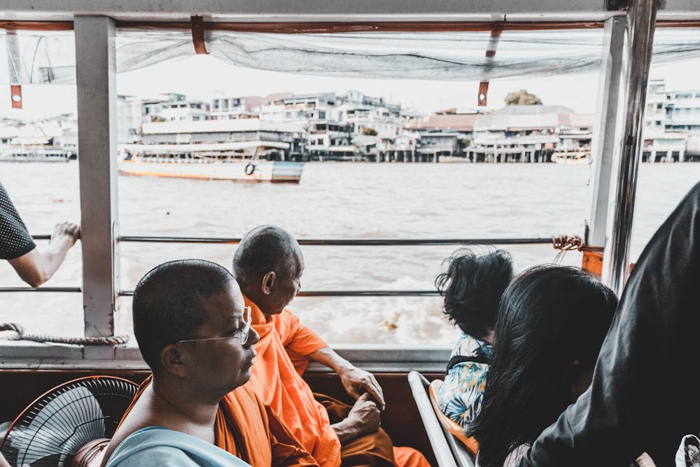 person sitting inside passenger boat at daytime