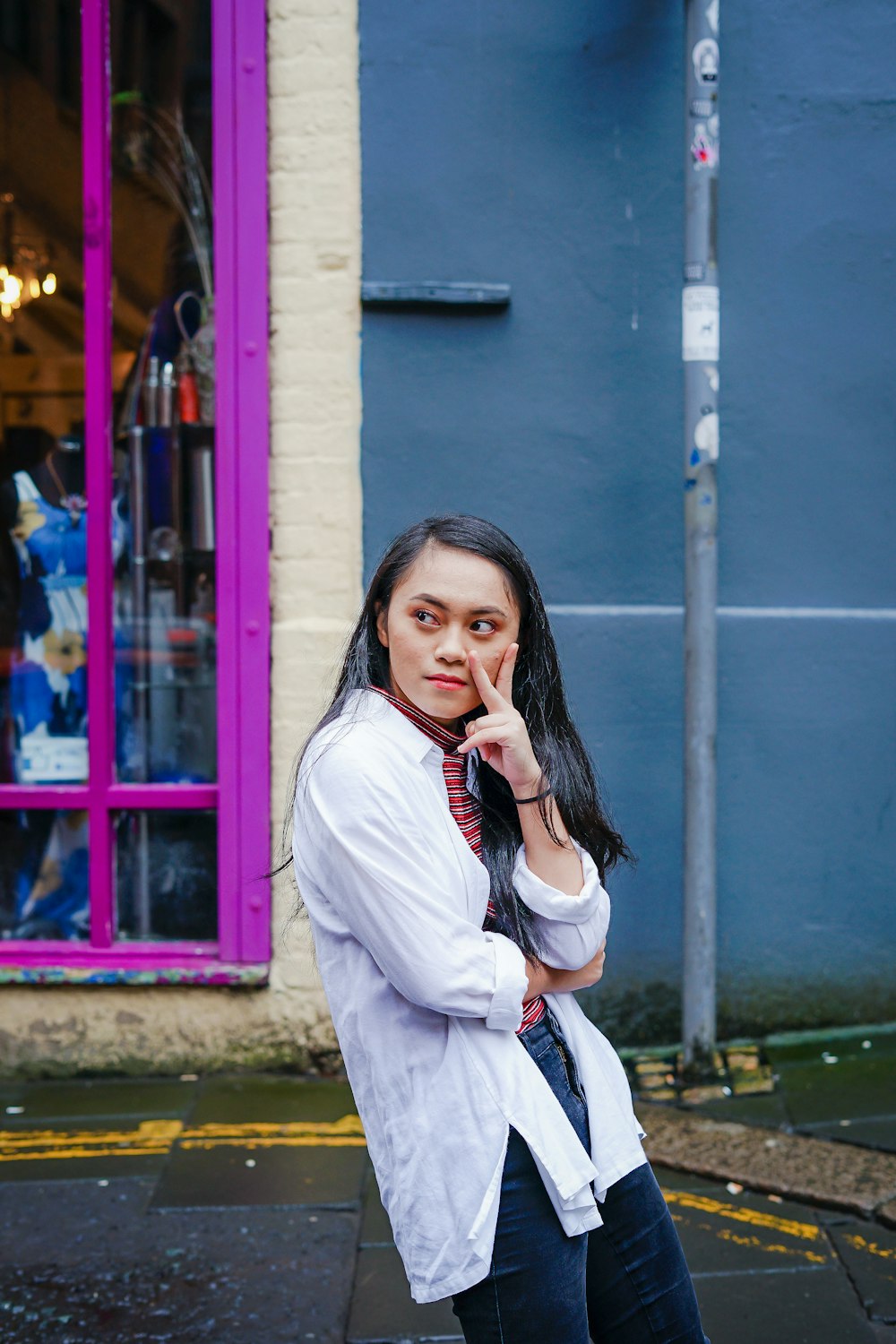 woman standing near blue wall