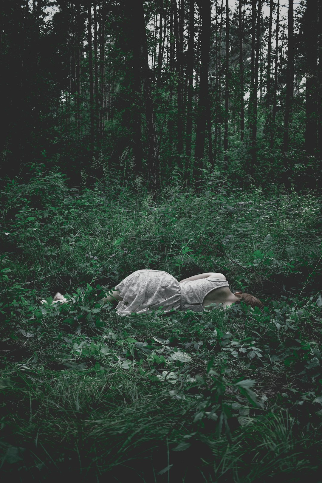 woman lying on green plants