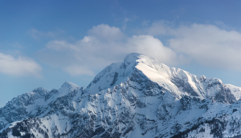 snow mountain under blue and white cloudy sky