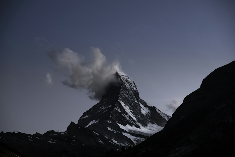 Warm alpenglow lighting the Matterhorn peak above Zermatt village