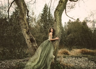 sepia photography of woman wearing princess dress hugging truck