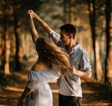 man and woman dancing at center of trees