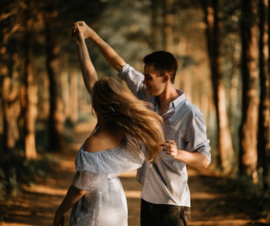 man and woman dancing at center of trees