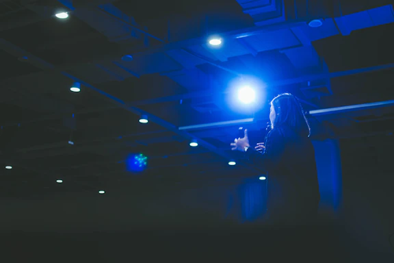 Portrait of José Brandão speaking passionately at a business seminar with a dark blue background.