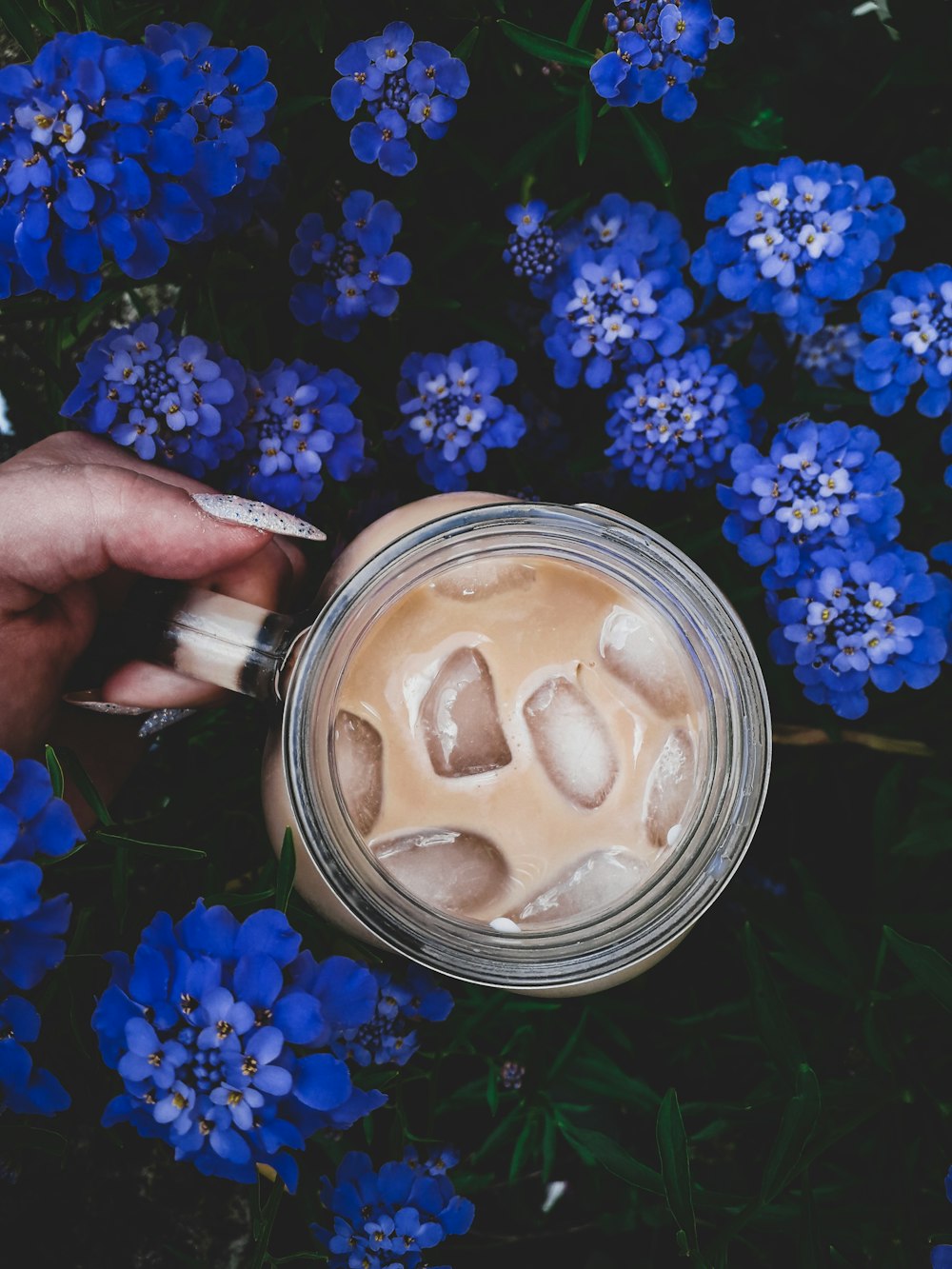 person holding jar of coffee