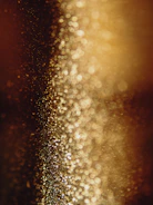 a blurry photo of some gold glitter