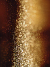 a blurry photo of some gold glitter