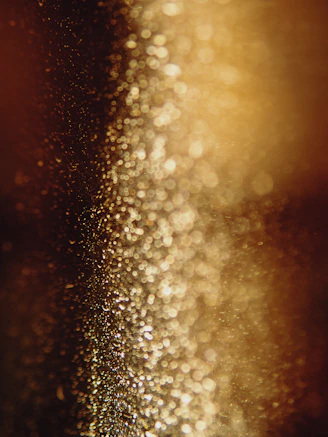 a blurry photo of some gold glitter