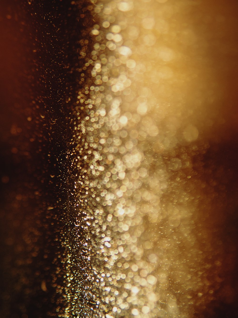 a blurry photo of some gold glitter
