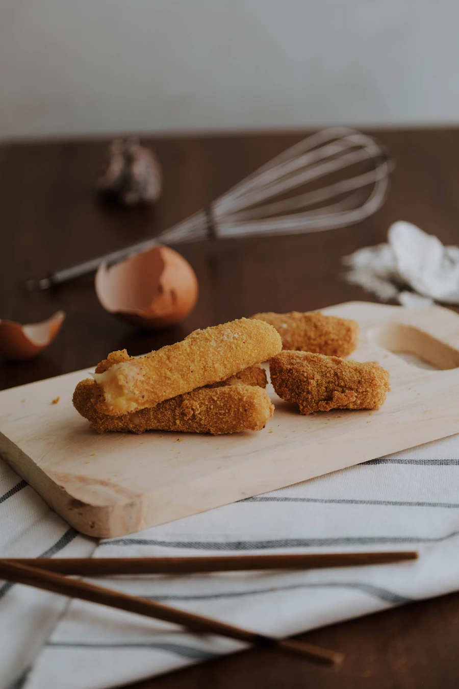 Crispy breaded mozzarella sticks with stretchy cheese pull and marinara sauce