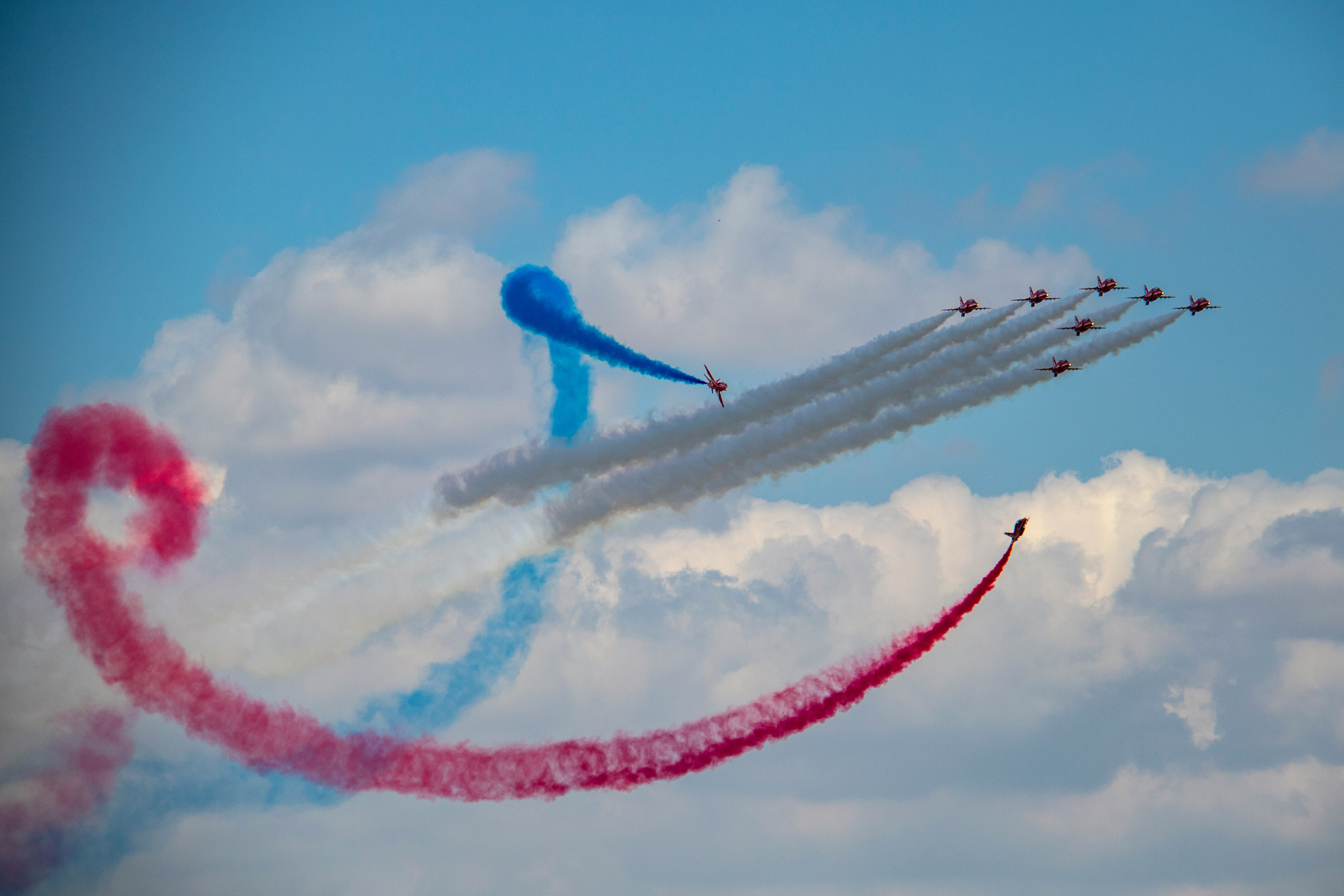 several fighter planes doing smoke exhibition